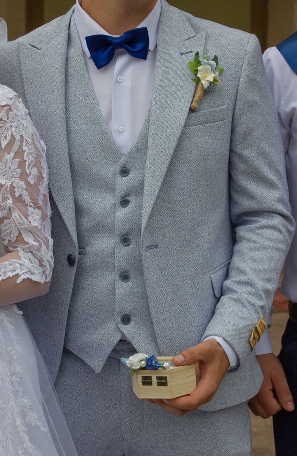 Man in a grey suit at a wedding