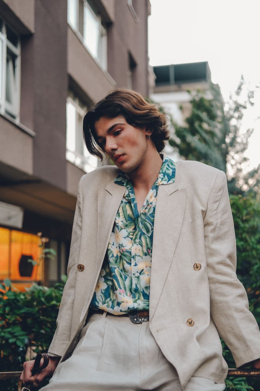 Man in a sand linen suit with a floral shirt