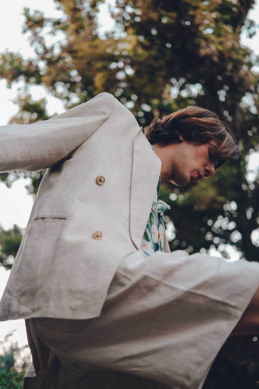 Man in a cream linen suit outdoors