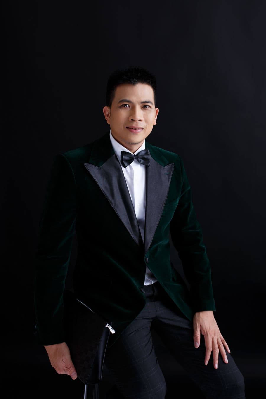 Man in a black velvet tuxedo with a bow tie