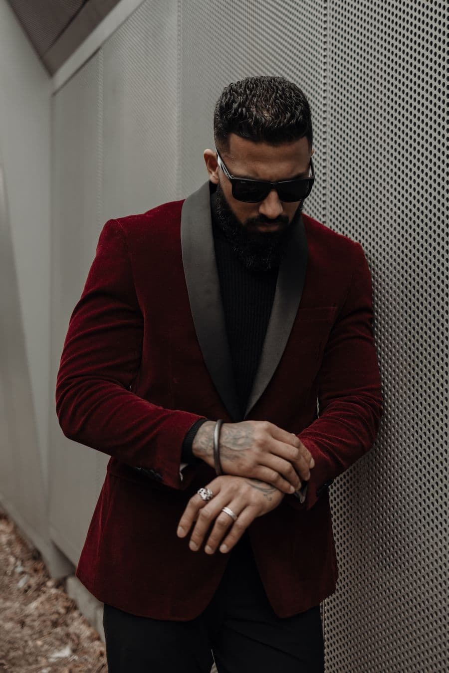 Man in a burgundy velvet jacket and black shirt