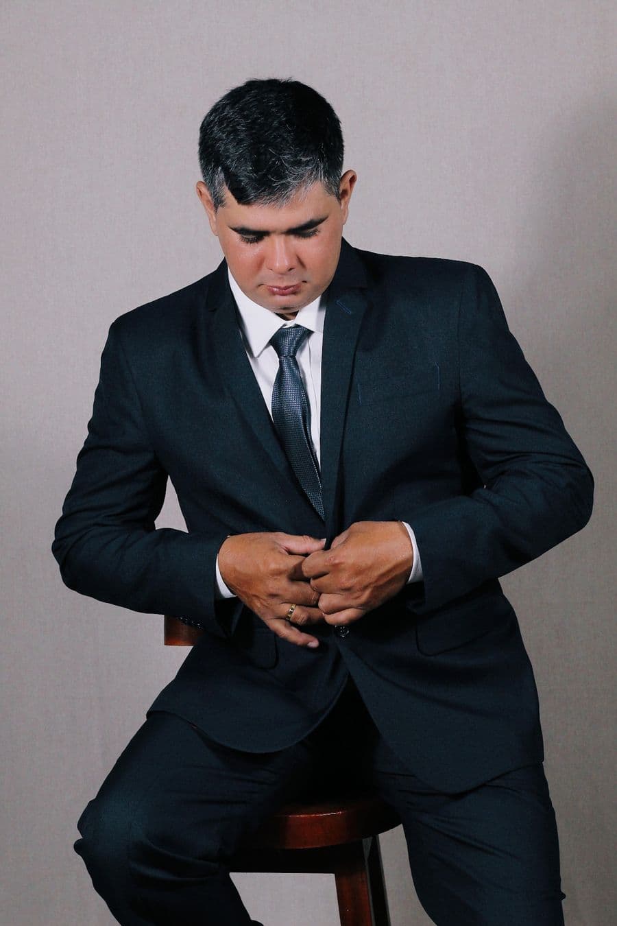 Man in a charcoal suit and dark tie