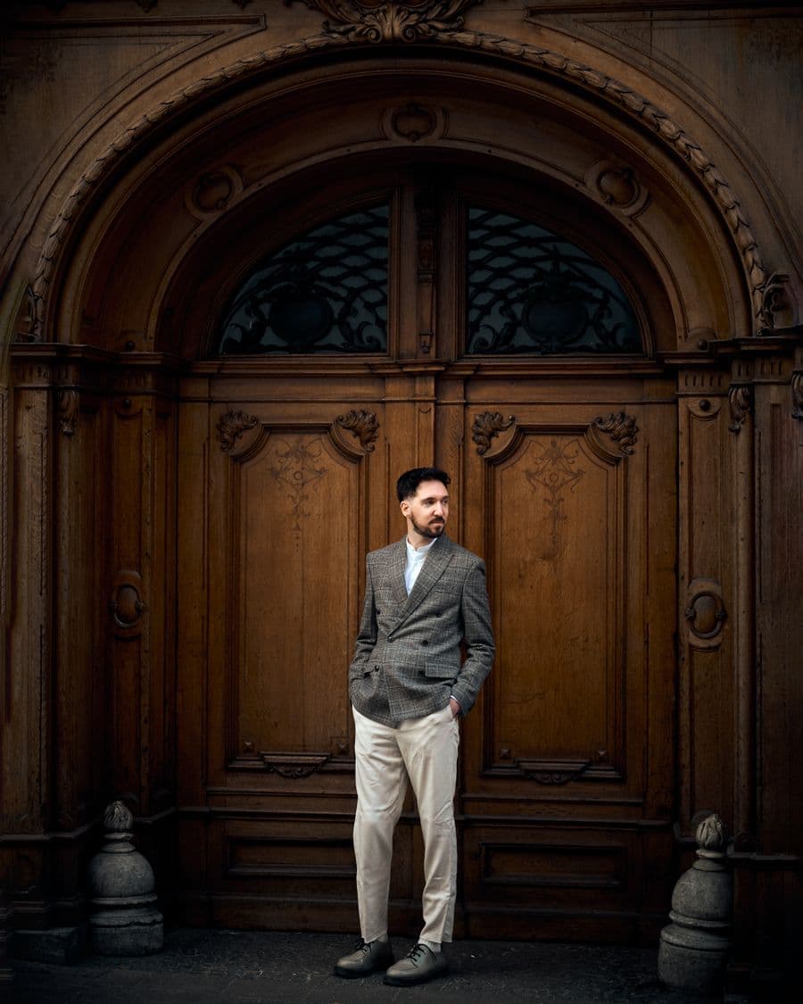 Man in a grey sport coat and stone trousers
