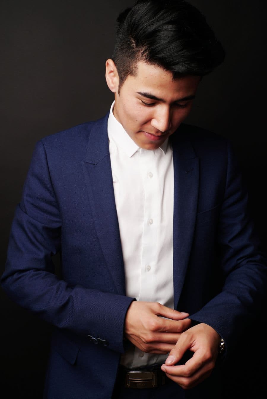 Man in a navy suit and white shirt, no tie