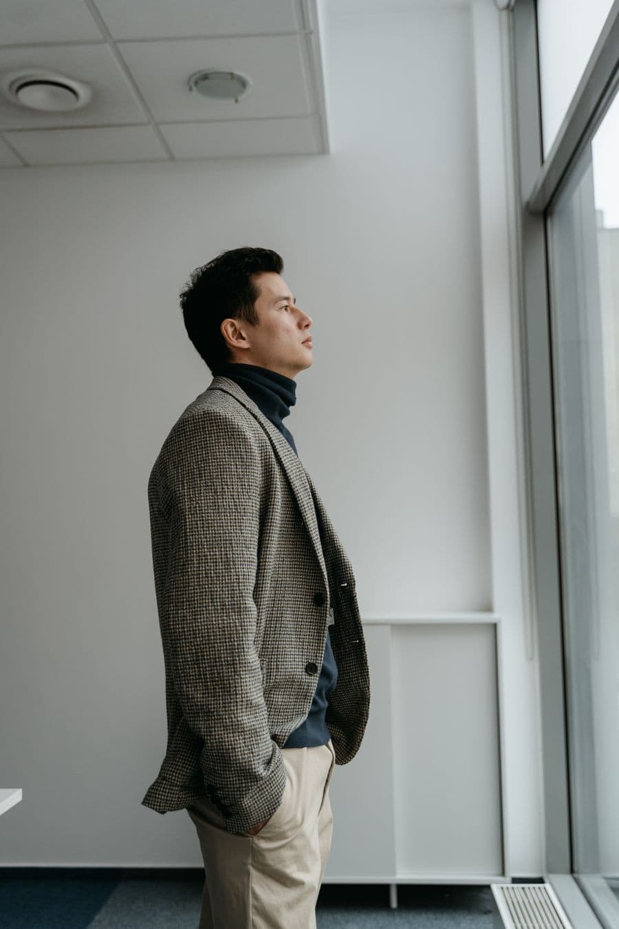 Man in a blazer over a black roll-neck